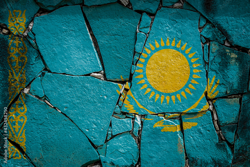 National flag of Kazakhstan depicting in paint colors on an old stone wall. Flag  banner on broken  wall background.