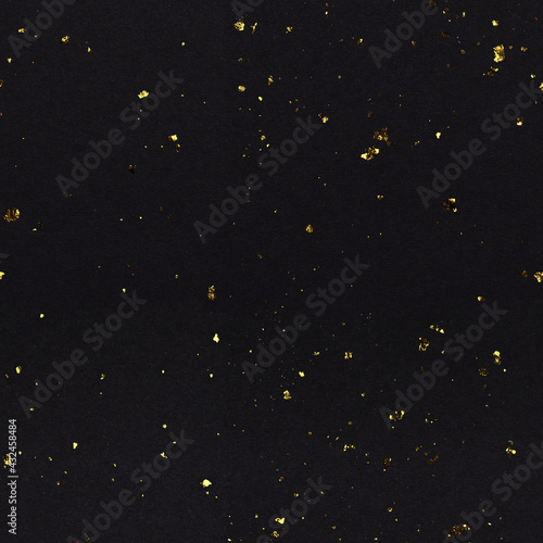 Seamless pattern with golden flakes of potal on black textured paper