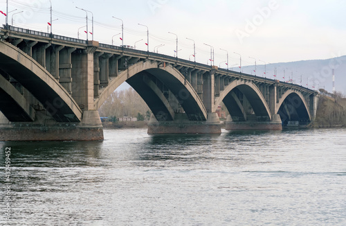 Large concrete transportation bridge across wide river in Siberia.