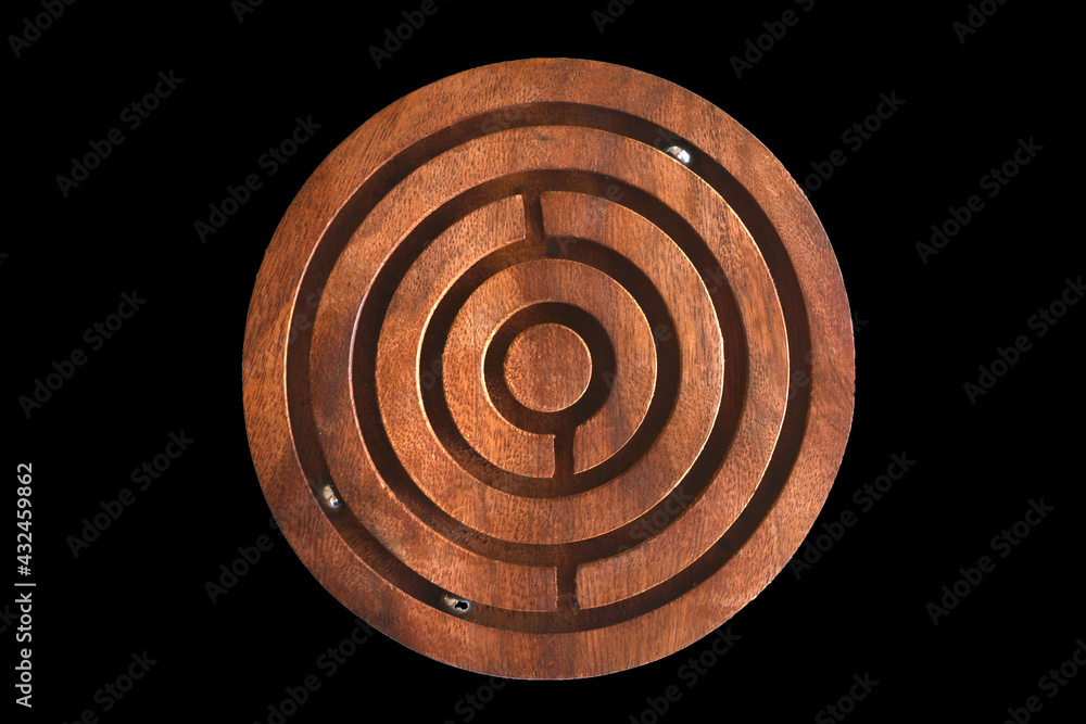 a round wooden labyrinth game on black backdrop a round wooden labyrinth game on black backdrop