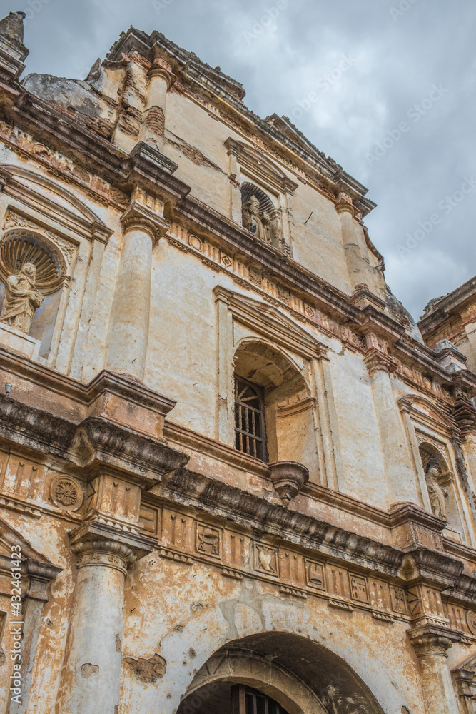 take detail of the facade of the convent and church with a classical architecture style in an old colonial city in the middle of a dark and cloudy afternoon