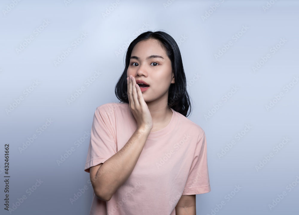 Surprised beautiful woman holding her cheeks by hand in amazement and open-mouthed. Happy young female model looks at camera as notices something unexpected hears good news. Oh! emotions and feelings Surprised beautiful woman holding her cheeks by hand in amazement and open-mouthed. Happy young female model looks at camera as notices something unexpected hears good news. Oh! emotions and feelings