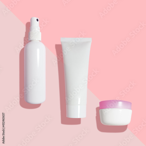 Creative beauty fashion concept photo of cosmetic recyclable bottle lotion cream on pink background.