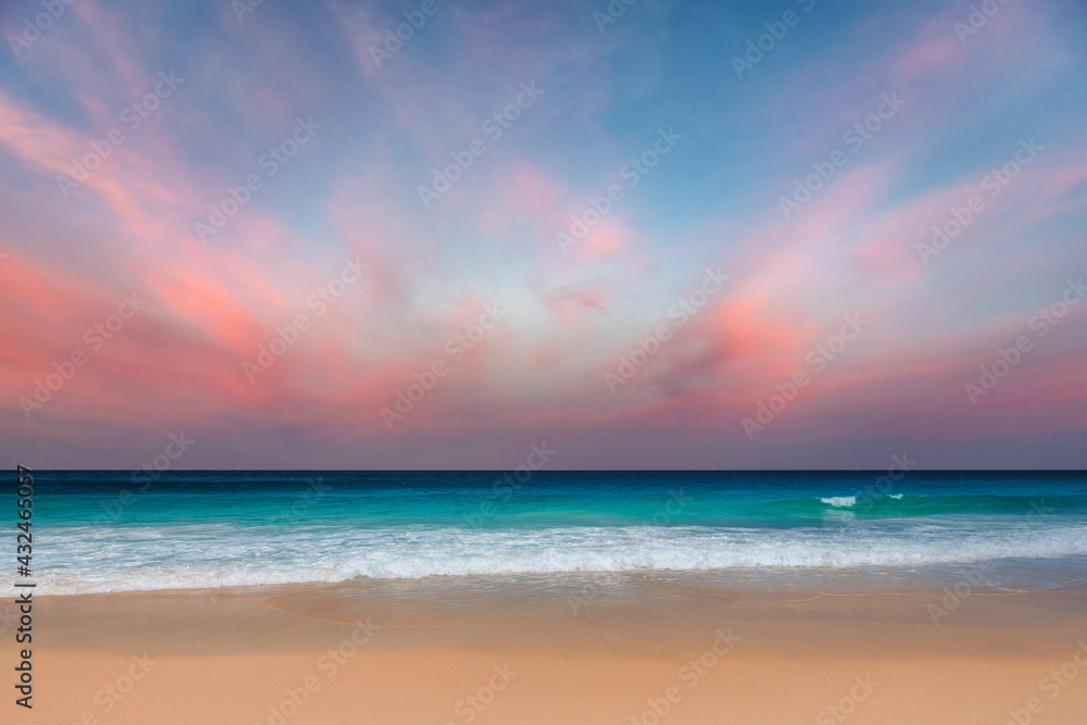 California beach at sunset. Pink clouds and blue sea. Sunset at tropical beach in Los Angeles, California.