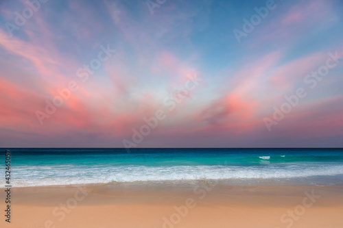California beach at sunset. Pink clouds and blue sea. Sunset at tropical beach in Los Angeles, California. © lucky-photo