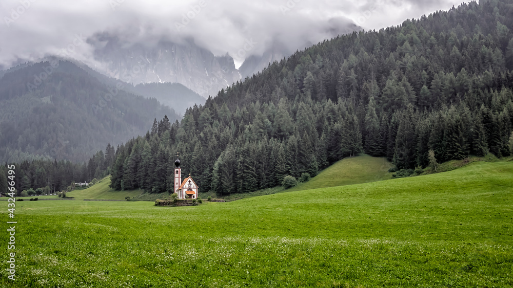 The scenery of the Dolomites with the St. John's in Ranui Chapel in Santa Maddalena. Italy