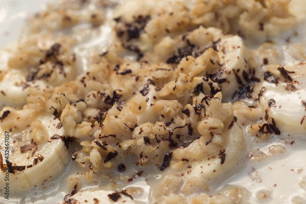 oat porridge with banana and chocolate closeup selective focus oat porridge with banana and chocolate closeup selective focus