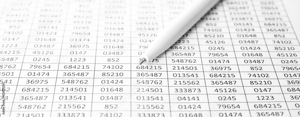 Worksheets or reports showing figures and white pen. Pen on financial data. Accounting. Concept of Business and Finance research. background banner Worksheets or reports showing figures and white pen. Pen on financial data. Accounting. Concept of Business and Finance research. background banner