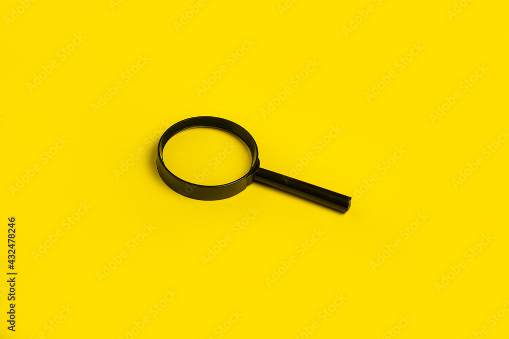 magnifying glass loupe search symbol on yellow background. Top view, flat lay magnifying glass loupe search symbol on yellow background. Top view, flat lay