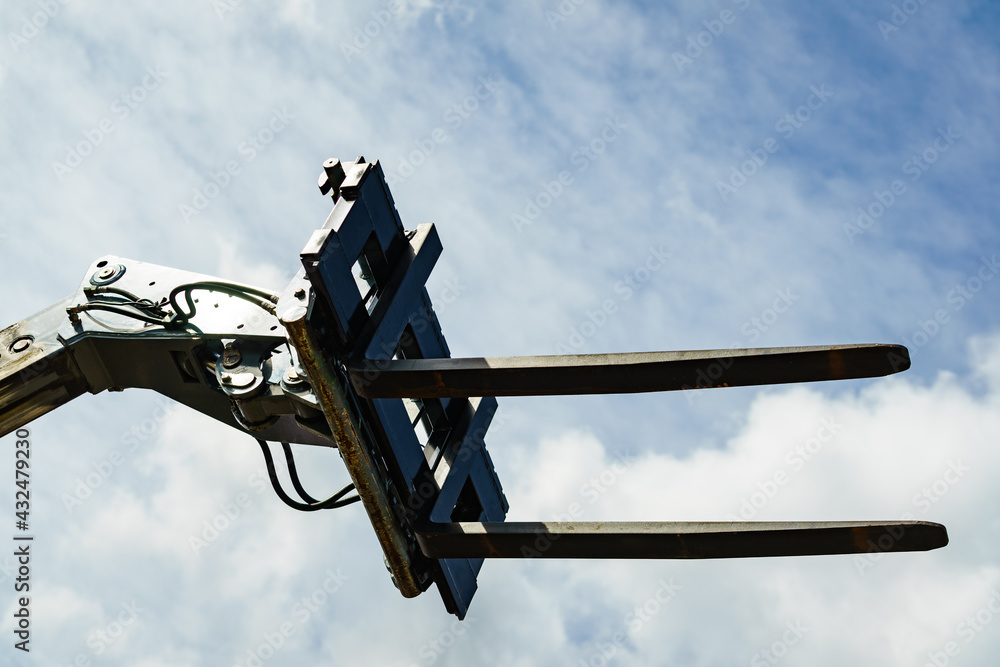 Forklift industrial loader or stacker against sky.