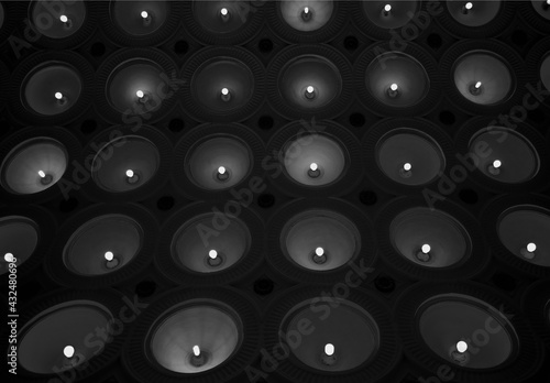 Black & white wall of glowing lamps photo