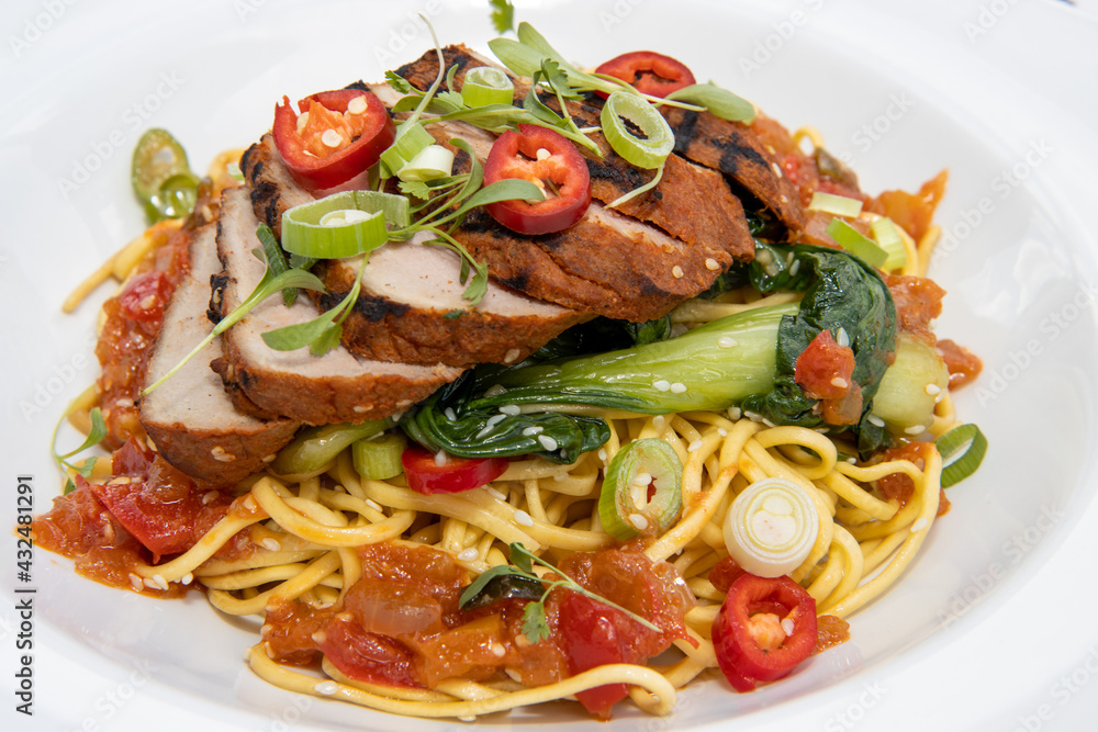 A delicious plate of spicy Chinese pork and noodles A delicious plate of spicy Chinese pork and noodles