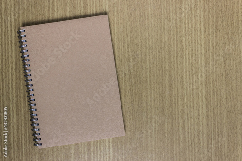 A brown notebook on table.