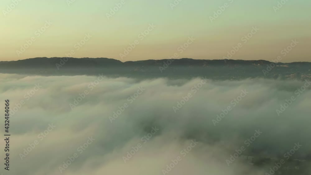 Aerial Shot Of Cloudscape Over Cityscape Against Sky At Sunset, Drone Flying Backward From Mountain Range - Los Angeles, California Aerial Shot Of Cloudscape Over Cityscape Against Sky At Sunset, Drone Flying Backward From Mountain Range - Los Angeles, California