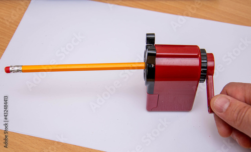 Sharpening a simple pencil with a sharpener.