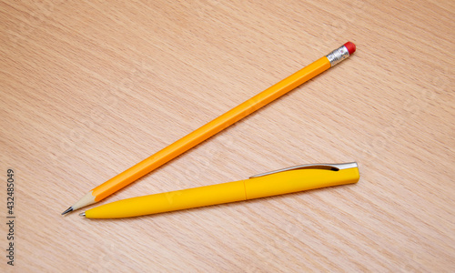 Yellow pencil and pen on the table.