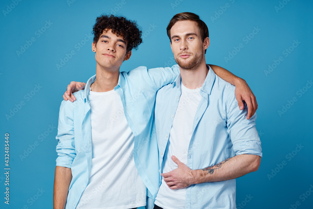 young men in blue shirts hugging on isolated background friends fun young men in blue shirts hugging on isolated background friends fun