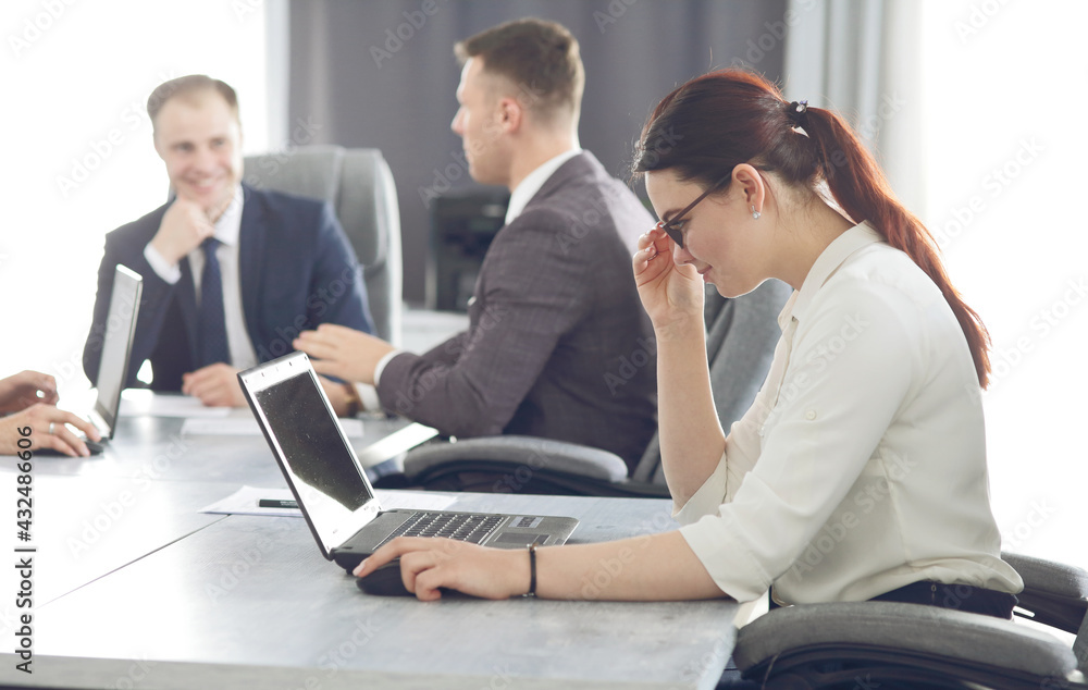 Fototapeta premium Young attractive business woman working in the office, developing her strategy