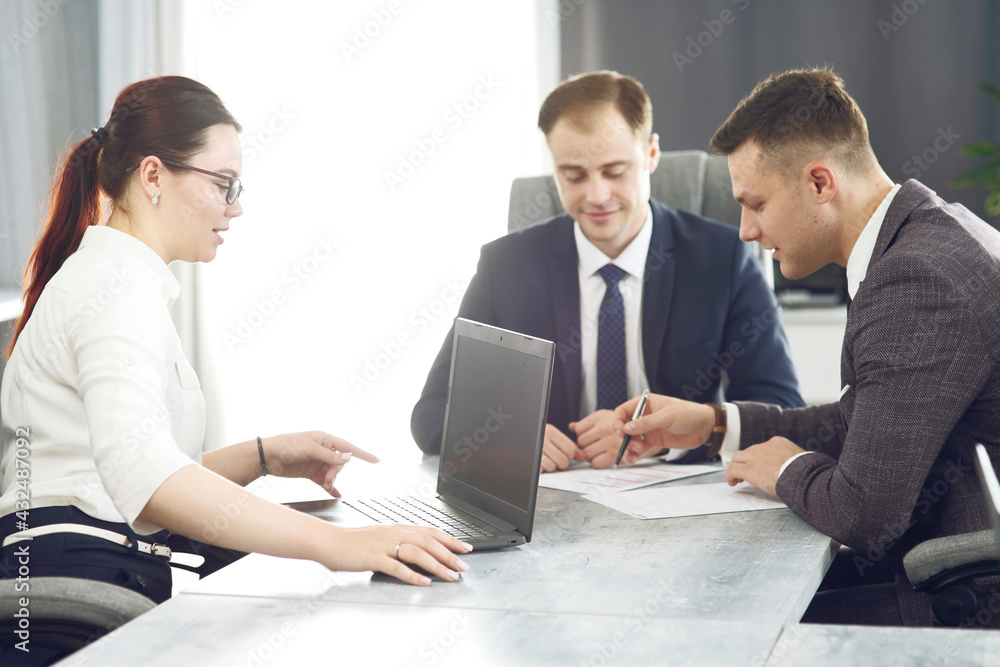 Group of young successful businessmen lawyers communicating together in a conference room while working on a project