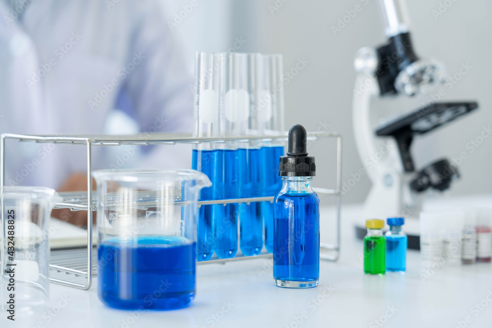 Scientist wear lab coat and protective wear are working with research or doing investigations with test tubes in experiment, Laboratory and development concept Scientist wear lab coat and protective wear are working with research or doing investigations with test tubes in experiment, Laboratory and development concept