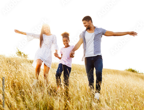 child daughter family happy mother father running active healthy carefree fun together girl cheerful field outdoor natur summer