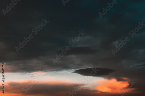Colorful clouds on twilight . Black thunderclouds at sunset