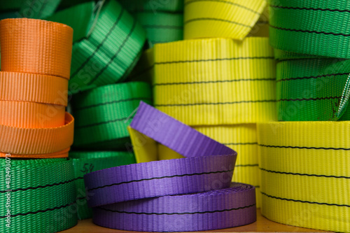 Industrial sewing machine sews a webbing sling. Manufacture of textile slings and tie straps.