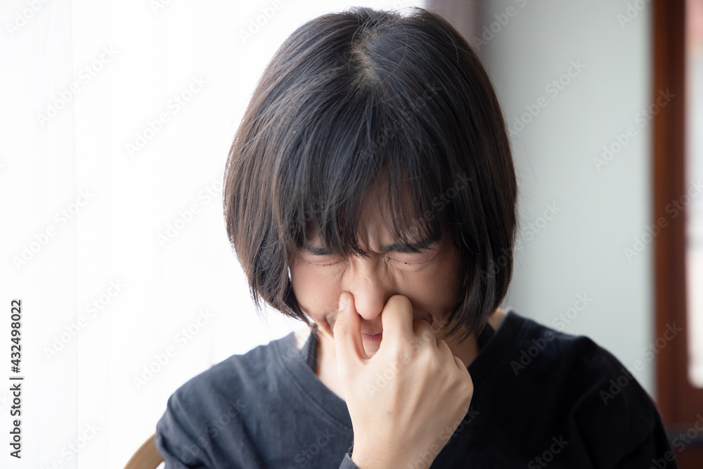 asian woman covering her nose for bad smell, concept of stink construction paint, bad breath, unpleasant smell, rotten food, odor, body bad smell, air pollution, polluted air asian woman covering her nose for bad smell, concept of stink construction paint, bad breath, unpleasant smell, rotten food, odor, body bad smell, air pollution, polluted air