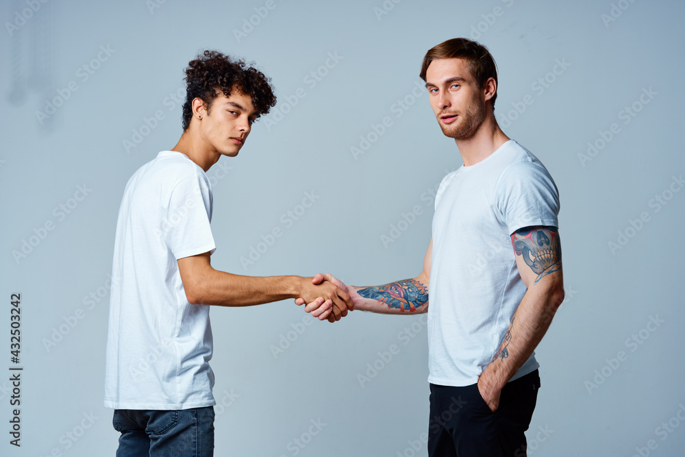two men friendship shaking hands isolated background two men friendship shaking hands isolated background