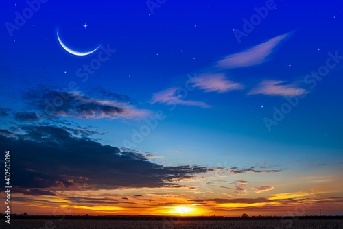 Crescent moon with beautiful sunset background . bright sky . sunset in hot summers  nature background