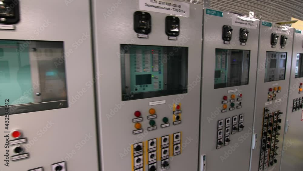 Motion along metal cabinets with modern switchboards and buttons at electrical distribution substation extreme close view Motion along metal cabinets with modern switchboards and buttons at electrical distribution substation extreme close view