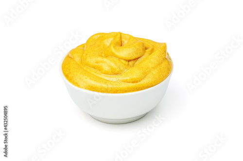 Yellow mustard sauce in white ceramic bowl isolated on white background.