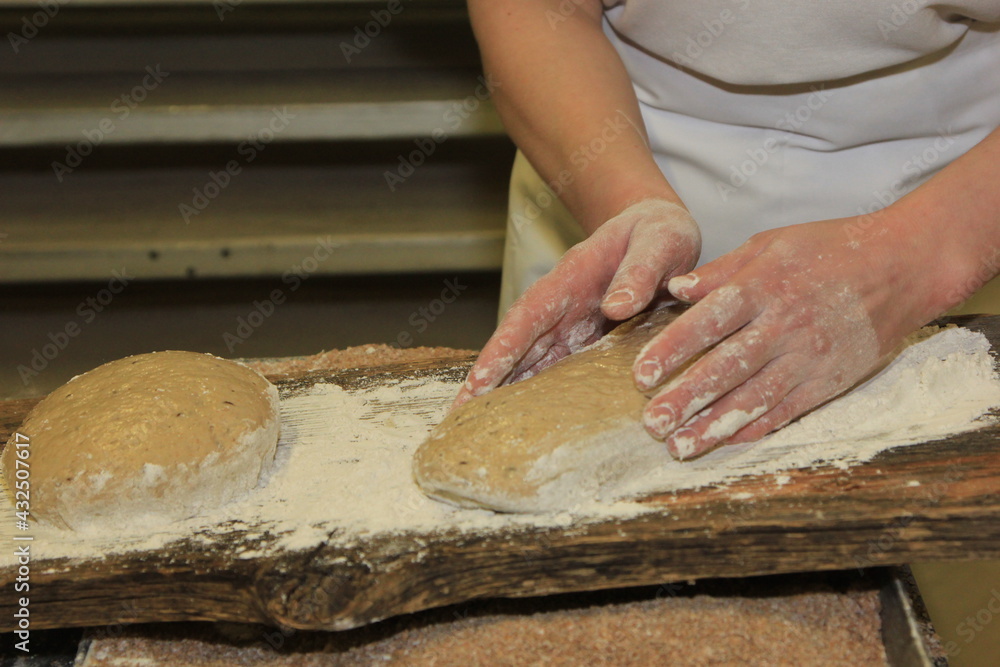 Woman's hands kneading the bread dough. Making dough by female hands on wooden table Woman's hands kneading the bread dough. Making dough by female hands on wooden table