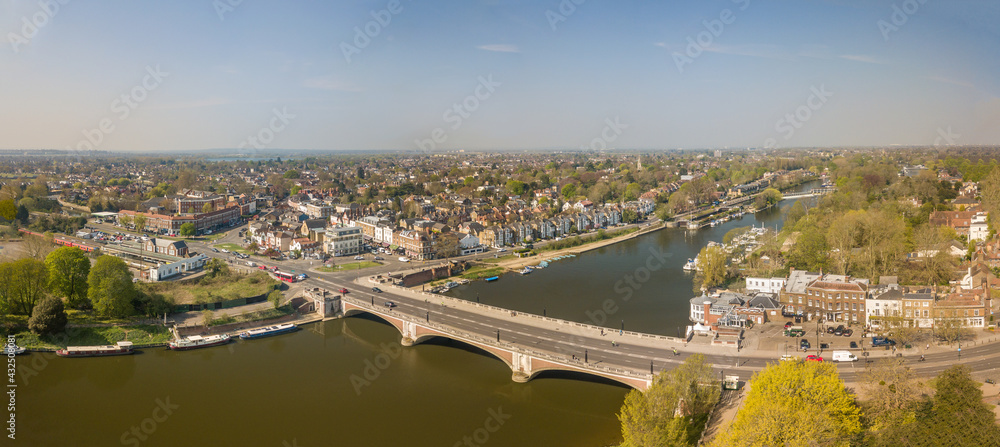 The drone aerial view of Hampton court bridge and East Molesey area in Greater London.