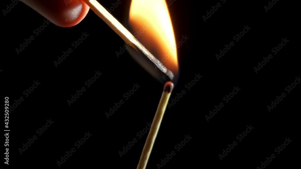 an unsuccessful attempt to light one match with another. black background an unsuccessful attempt to light one match with another. black background