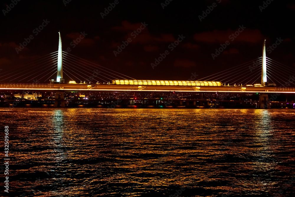 Naklejka premium Evening boat trip on the Bosphorus in Istanbul. Bosphorus Bridge, in the night lights