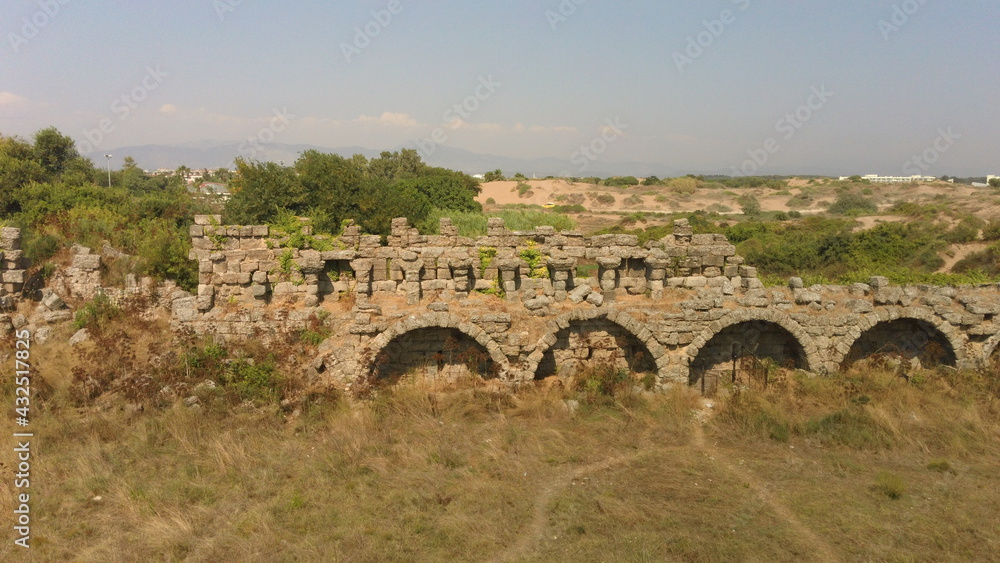 Ancient architecture of the stone bridge in the Byzantine style on a hot sunny summer day