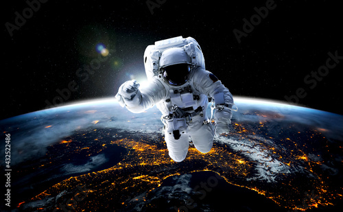 Astronaut spaceman do spacewalk while working for space station in outer space . Astronaut wear full spacesuit for space operation . Elements of this image furnished by NASA space astronaut photos. photo