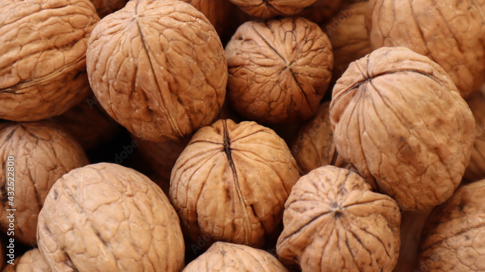 Natural Walnuts with shell background pattern texture. Background of fresh walnuts in shell. Lots of Walnuts with shell at the market in Istanbul Natural Walnuts with shell background pattern texture. Background of fresh walnuts in shell. Lots of Walnuts with shell at the market in Istanbul