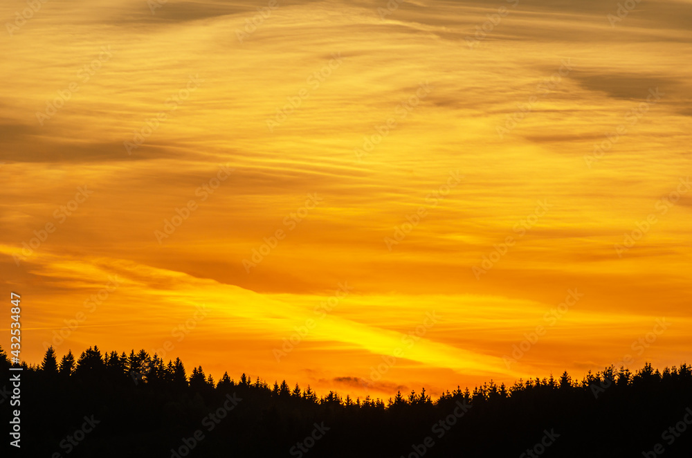 Golden sky at sunset over the mountains, vivid natural colors, background 