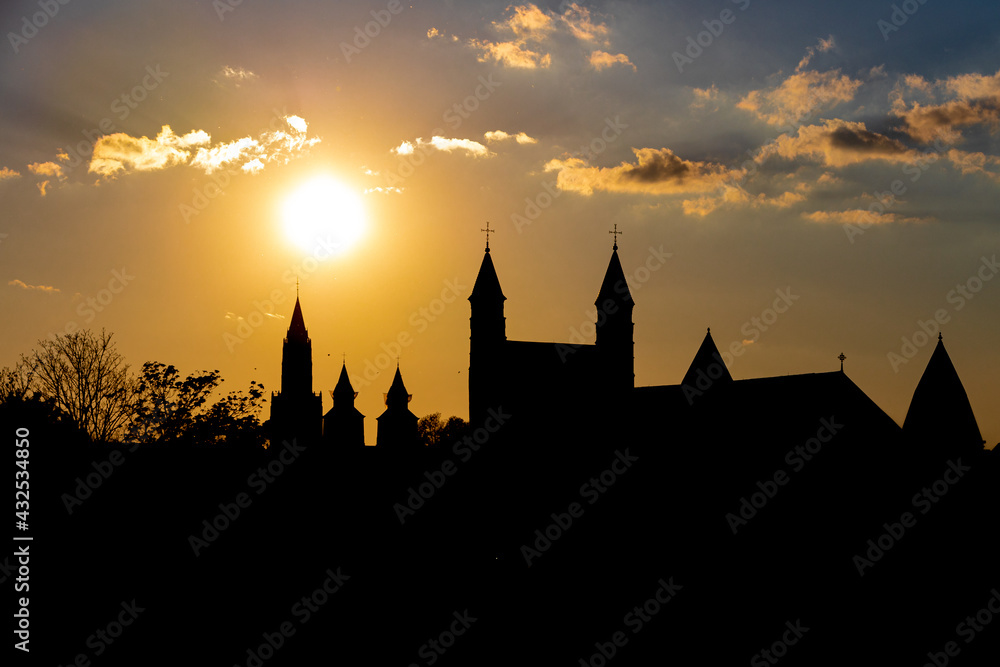 Skyline of downtown Maastricht during sunset creating amazing silhouettes of the various churches in the center of town