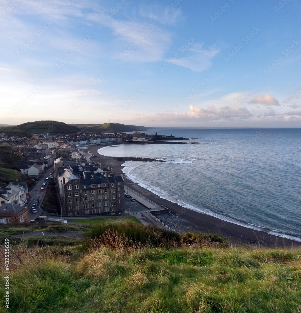 Early morning view from Constitution Hill Craig-glais towards Aberystwyth North Beach Traeth y Gogledd seafront and promenade in Ceredigion, West Wales, UK