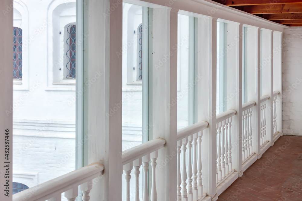 Fototapeta premium Empty long glass window hallway corridor in the public castle museum building. Connection walkway.