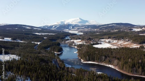 Åre Sweden mountain ski activity resort and lake river. Aerial drone shot in snow winter on a sunny day in swedish nature photo