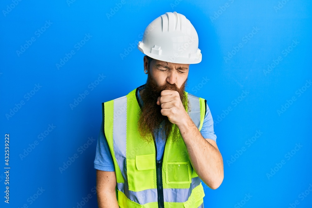 Redhead man with long beard wearing safety helmet and reflective jacket feeling unwell and coughing as symptom for cold or bronchitis. health care concept.