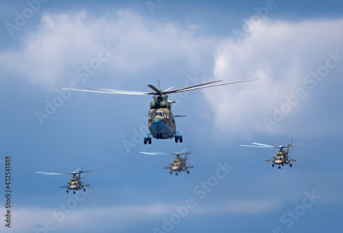 MOSCOW, RUSSIA - MAY 7, 2021: Avia parade in Moscow. Mi-26 and Mi-8AMTK helicopters fly in the sky on parade of Victory in World War II in Moscow, Russia