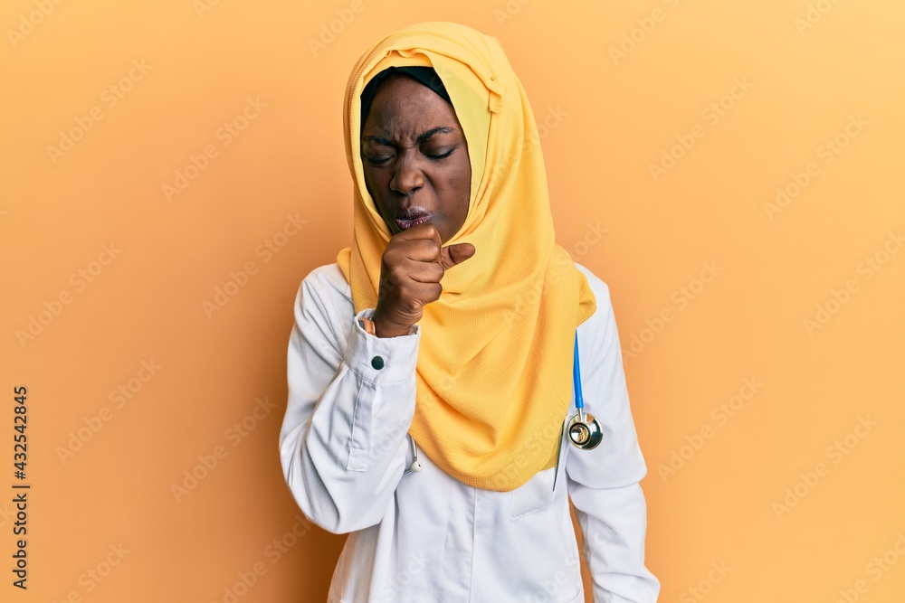 Beautiful african young woman wearing doctor uniform and hijab feeling unwell and coughing as symptom for cold or bronchitis. health care concept. Beautiful african young woman wearing doctor uniform and hijab feeling unwell and coughing as symptom for cold or bronchitis. health care concept.