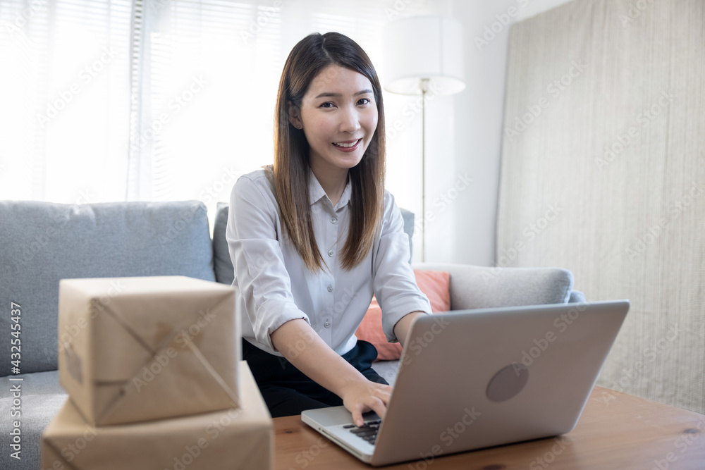 Beautiful young Asian businesswoman working from home, Online ordering and delivery services, Online marketing, SME. Beautiful young Asian businesswoman working from home, Online ordering and delivery services, Online marketing, SME.