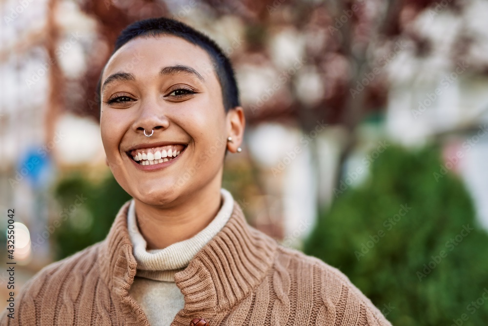Beautiful hispanic woman with short hair smiling happy outdoors Beautiful hispanic woman with short hair smiling happy outdoors
