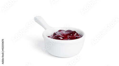 Jam in a gravy boat isolated on a white background. Purple jam.